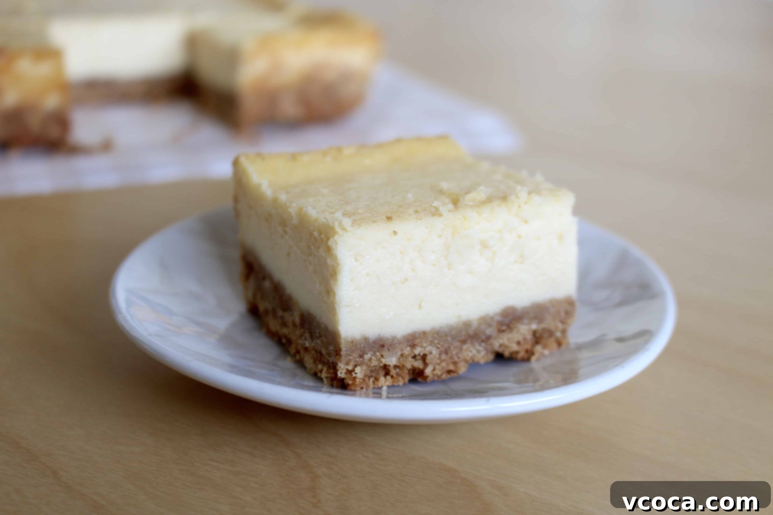 Close-up of cut cheesecake bars, revealing the creamy texture