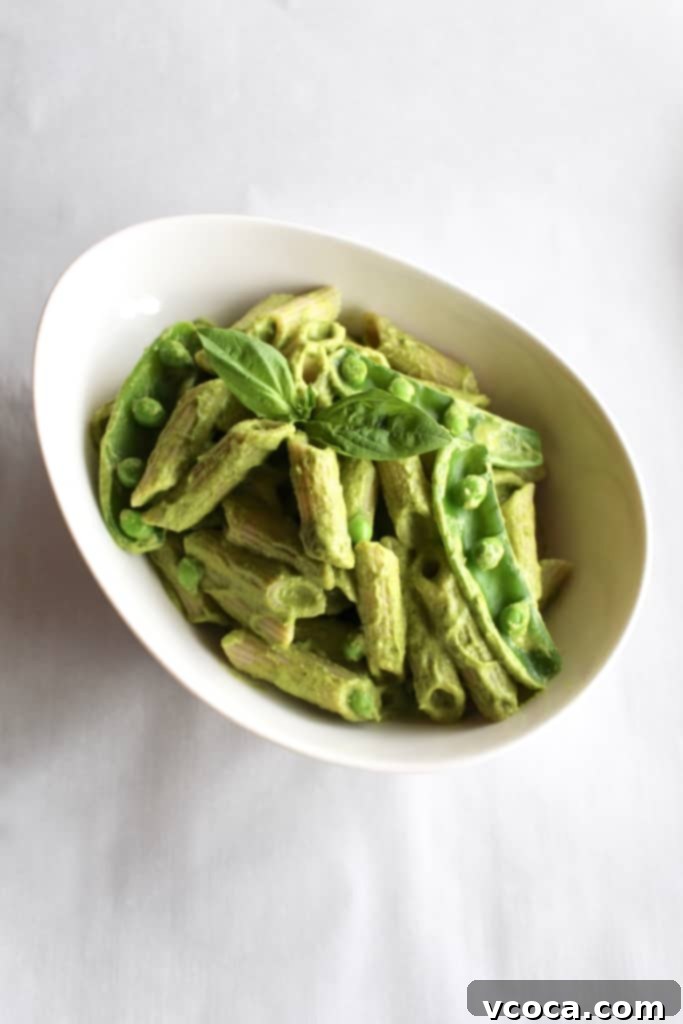 Green Vegan Mac and Cheese Healthy Twist 2 Vibrant green vegan mac and cheese with penne pasta, naturally colored by vegetables like spinach and romanesco broccoli