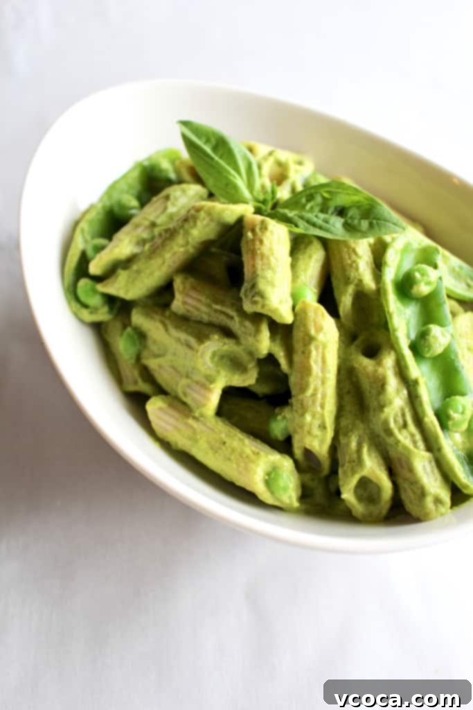 Green Vegan Mac and Cheese Healthy Twist 4 Delicious bowl of green vegan pesto mac and cheese, featuring penne pasta and a rich, creamy sauce