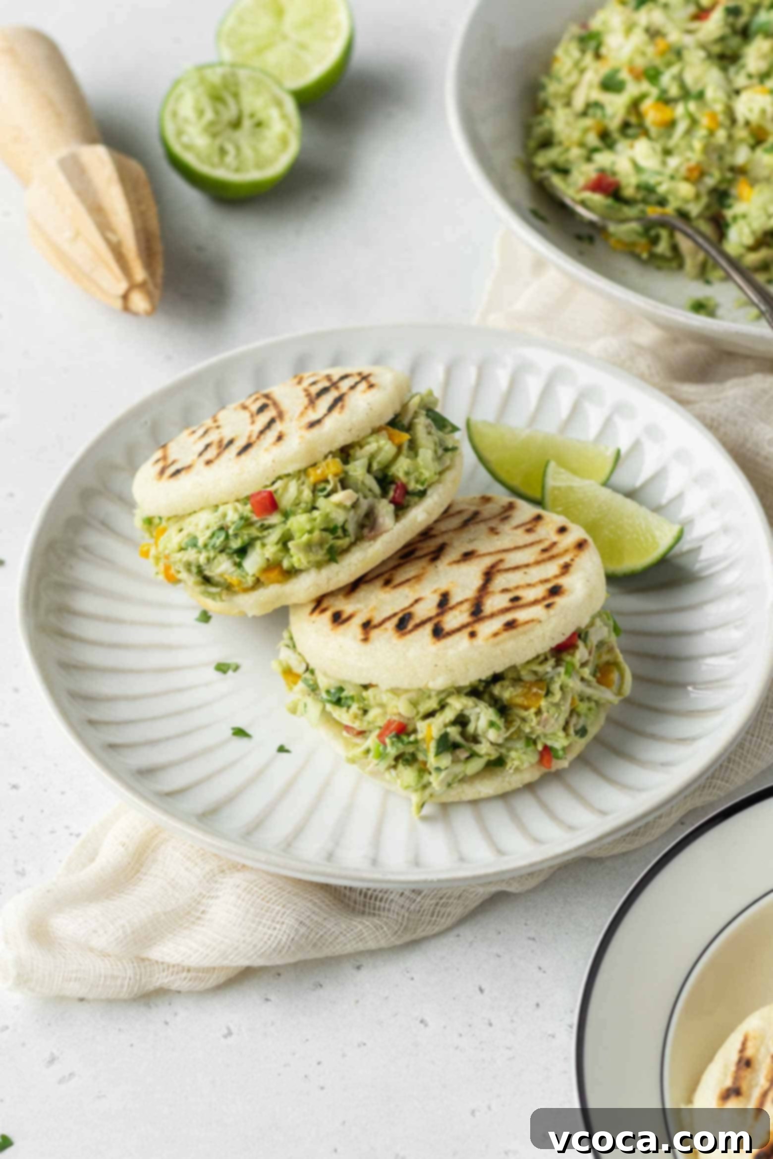 Reina Pepiada Venezuelan Arepas 11 Two generously filled Reina Pepiada arepas on a plate, ready to be enjoyed