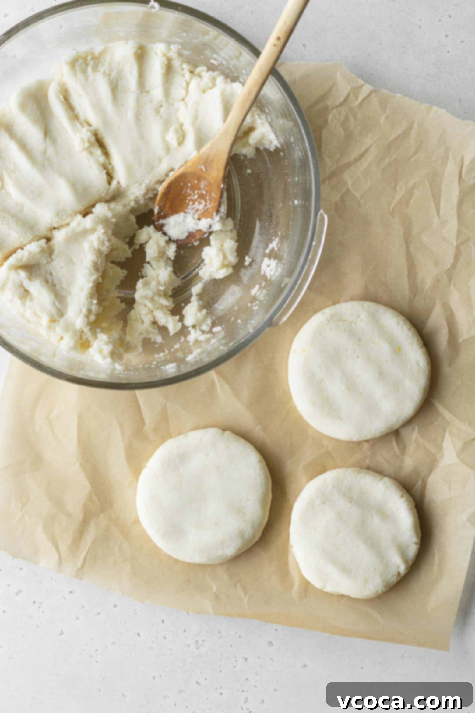 Reina Pepiada Venezuelan Arepas 7 Hands shaping arepas from homemade dough, demonstrating the flattening process