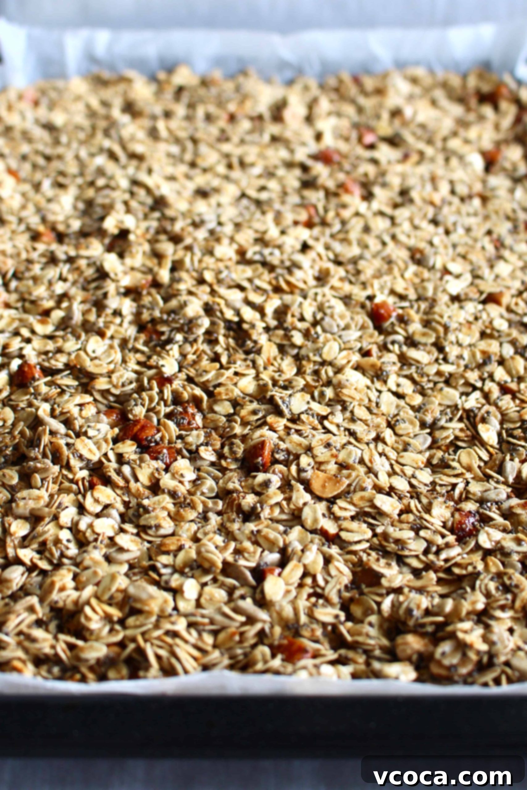 Seriously Delicious Gluten-Free Granola 5 Gluten free granola spread onto a baking sheet.
