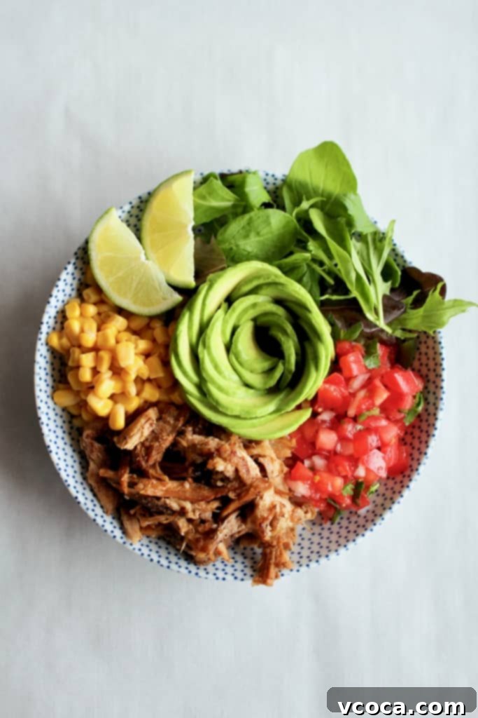 This is THE BEST slow cooker carnitas! So easy to make, yet so tender, crispy, and full of flavor! #carnitas #slowcooker #crockpot #pulledpork #porkshoulder #porkbutt #mexican #mexico #orange #garlic #onions #spices #cilantro #lime #avocado #tacos #arepas #salad #ricebowl #pasta