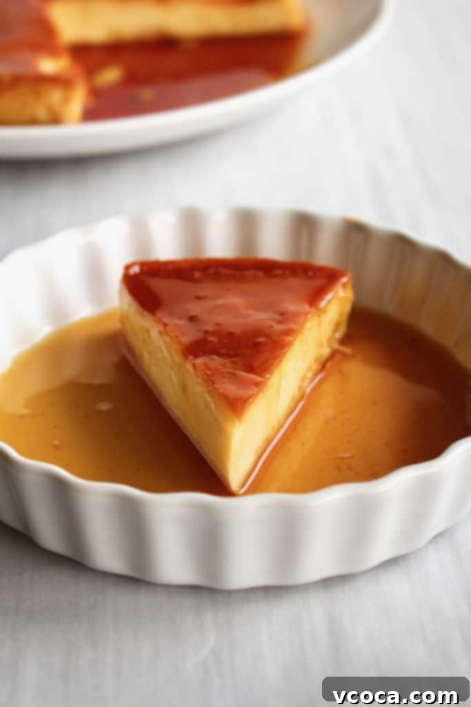 A perfectly sliced piece of dairy-free leche flan on a white plate