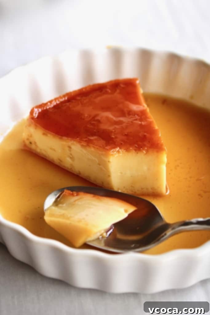 A delectable slice of Filipino leche flan with a spoon, highlighting its creamy texture