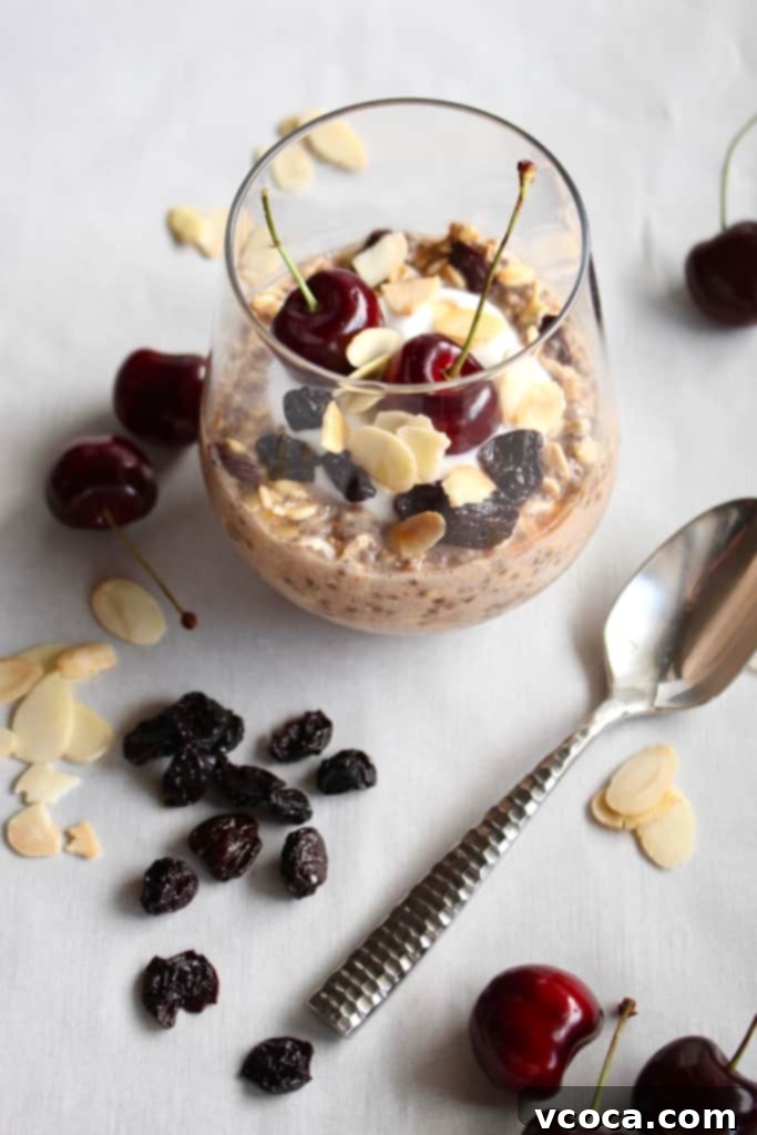 A single glass of creamy overnight oats with a silver spoon resting beside it, ready to be enjoyed as a quick and healthy breakfast.