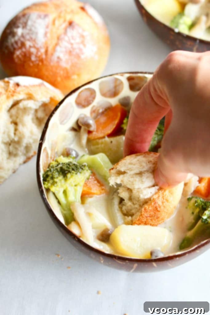 Vegan Japanese Cream Stew with Jackfruit 10 A close-up of a spoon scooping Vegan Japanese Cream Stew, showing the creamy texture and the chunks of jackfruit and vegetables. The focus is on the deliciousness and hearty nature of the stew.
