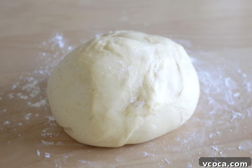Decadent Strawberry Chocolate Rolls 3 Soft, rested bread dough on a floured surface, ready to be rolled