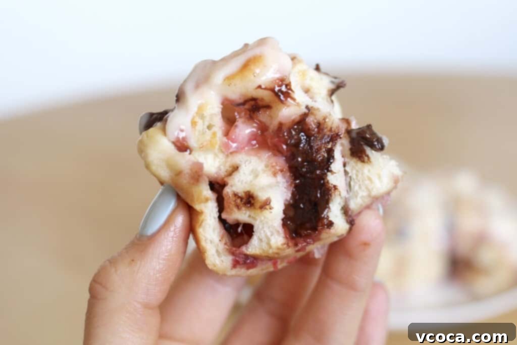 Decadent Strawberry Chocolate Rolls 10 Close-up of a strawberry chocolate roll showing fluffy interior and melted filling