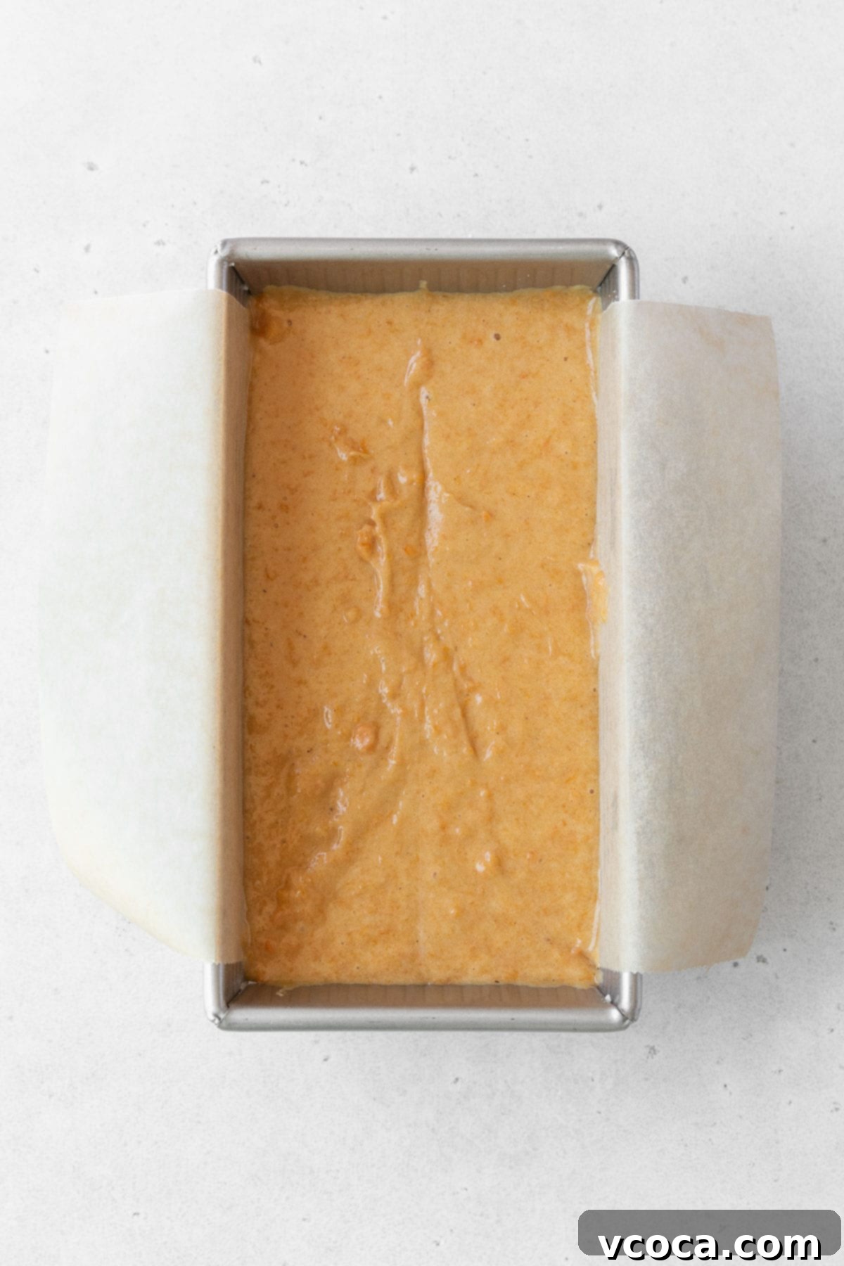 Spiced Sweet Potato Cake with Cashew Frosting 13 Gluten free sweet potato loaf in a metal loaf pan lined with parchment paper.
