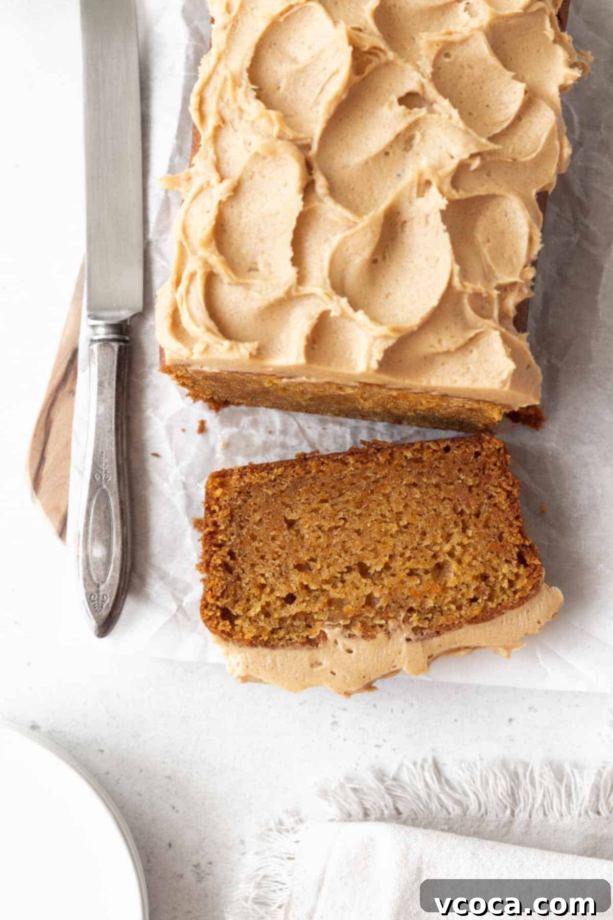 Spiced Sweet Potato Cake with Cashew Frosting 15 An overhead shot of sweet potato cake with a piece sliced off.