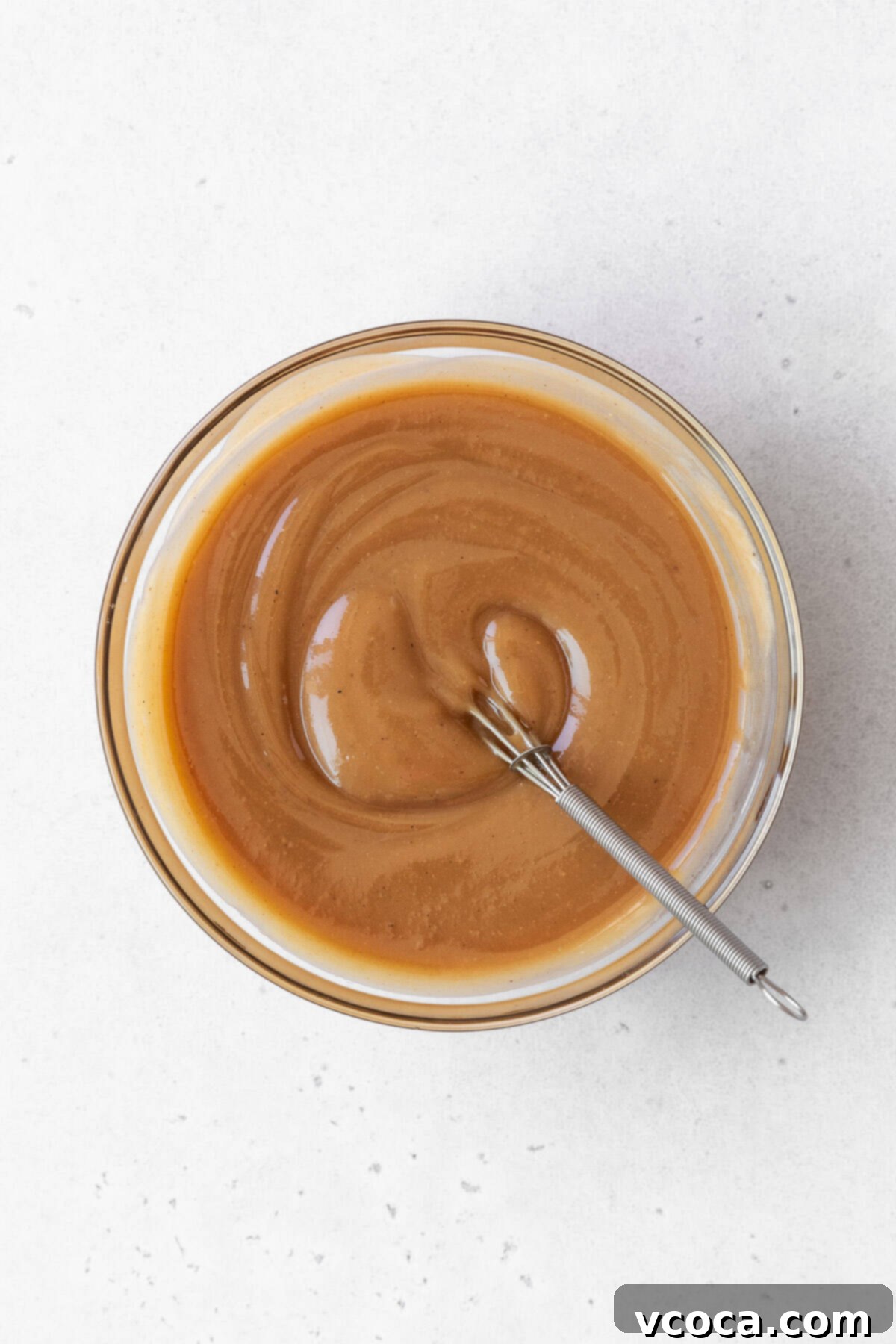 Spiced Sweet Potato Cake with Cashew Frosting 16 A bowl of maple cashew frosting ingredients mixed together in a glass bowl.