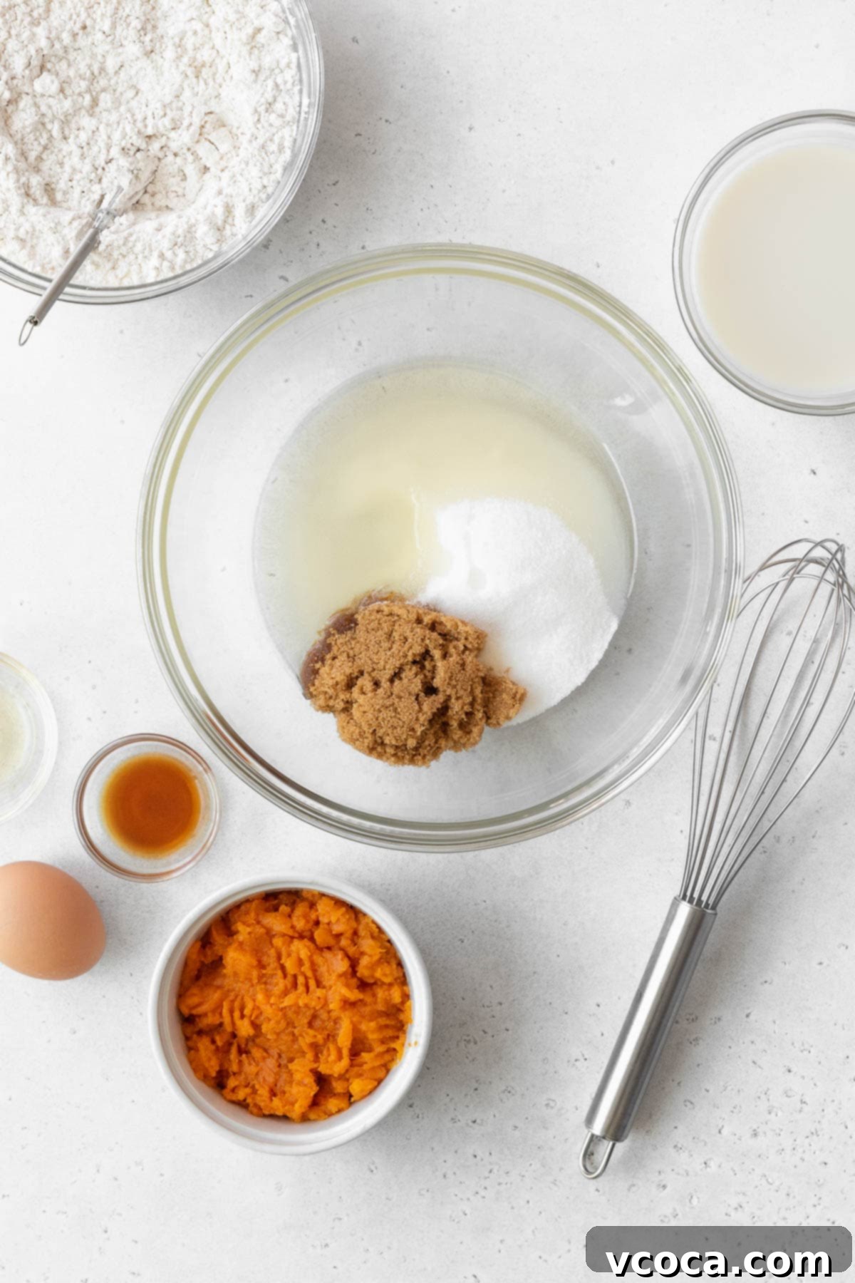 Spiced Sweet Potato Cake with Cashew Frosting 8 A large glass bowl with oil, granulated sugar, and brown sugar.