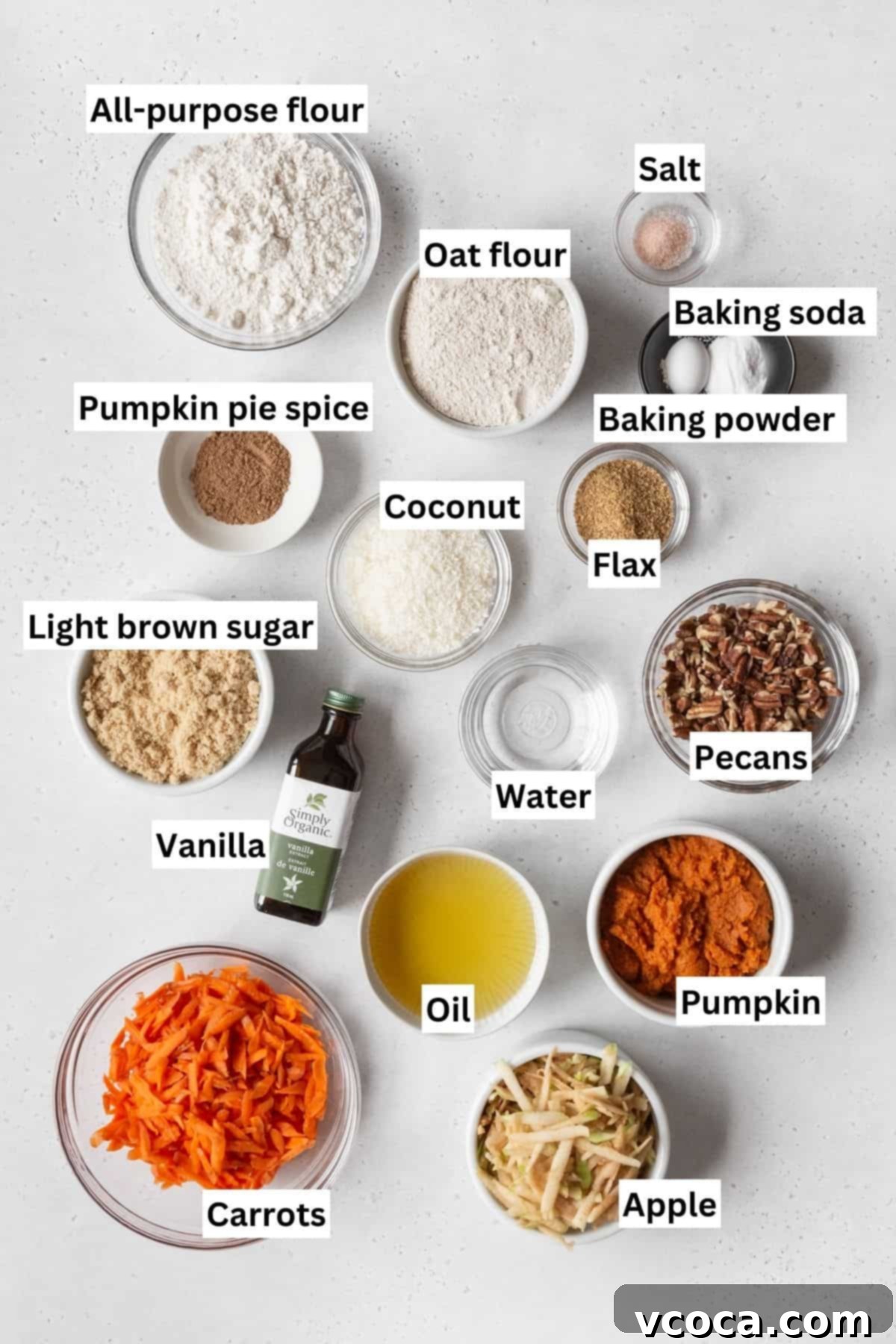 Vibrant Morning Glory Muffins Healthy Gluten Free 3 All the dry and wet ingredients for healthy pumpkin morning glory muffins measured out into individual bowls on a white table, ready for mixing.