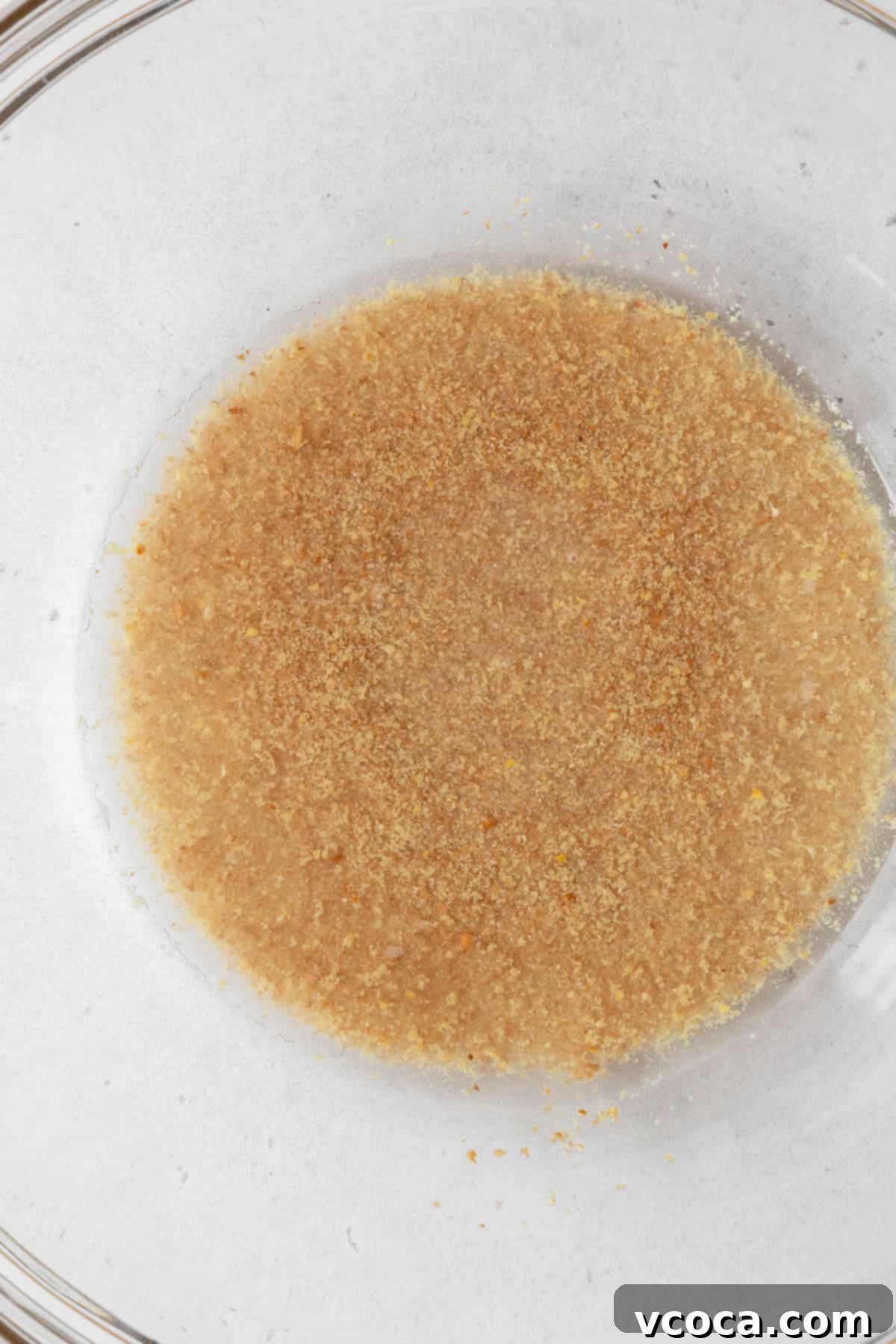 Vibrant Morning Glory Muffins Healthy Gluten Free 5 Process shot showing ground flaxseed soaking in water in a glass bowl to create a vegan egg substitute.