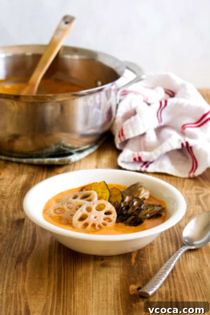 Creamy, spicy vegan coconut curry with root vegetables and mushrooms, perfect for a warm winter meal. Healthier and tastier than takeout, featuring lotus root, kabocha, and maitake mushrooms. #vegan #coconutmilk #coconutcurry #curry #indiancurry #thaicurry #winter #rootvegetables #vegetables #delicious #comfortfood #recipe #spicy #creamy #glutenfree #lotusroot #kabocha #maitake #mushrooms