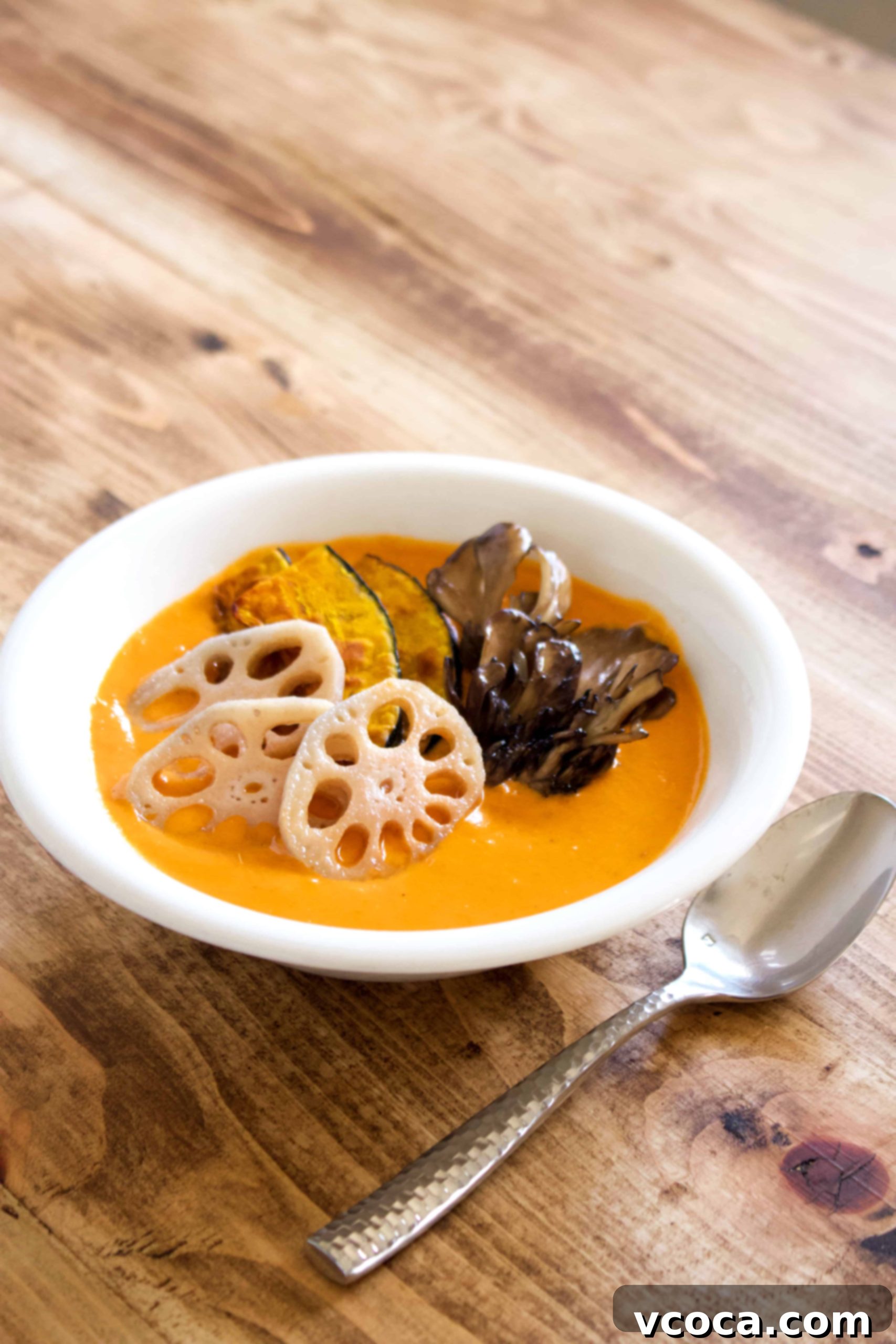 Delicious and creamy vegan coconut curry, a heartwarming winter dish packed with vegetables. #vegan #coconutmilk #coconutcurry #curry #indiancurry #thaicurry #winter #rootvegetables #vegetables #delicious #comfortfood #recipe #spicy #creamy #glutenfree #lotusroot #kabocha #maitake #mushrooms