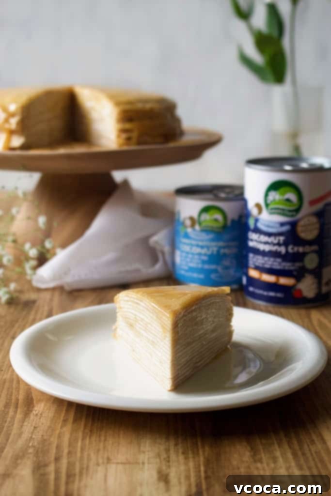 Golden Vegan Dulce de Leche Mille Crepe Cake 2 A slice of Vegan Dulce de Leche Mille Crepe Cake showcasing layers of crepes and coconut whipped cream, topped with rich homemade dulce de leche. This impressive dessert is dairy-free and perfect for any occasion.