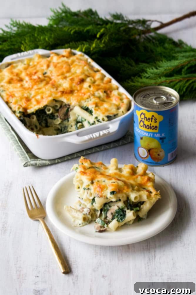 Creamy Umami Vegan Macaroni Gratin 2 A generous serving of creamy vegan macaroni gratin on a white plate, topped with golden-brown vegan cheese and fresh parsley.
