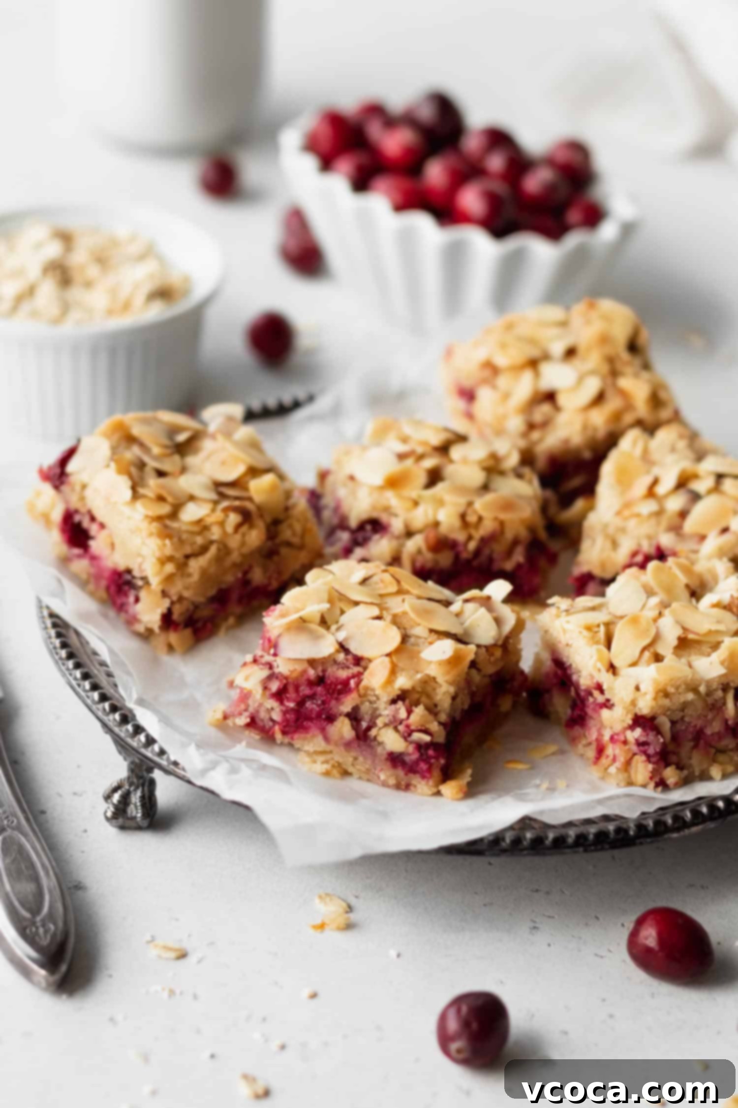 Gluten Free and Dairy Free Cranberry Oat Bars 2 Delicious gluten-free dairy-free cranberry oat bars arranged on a platter, showcasing their golden-brown top and vibrant red filling.