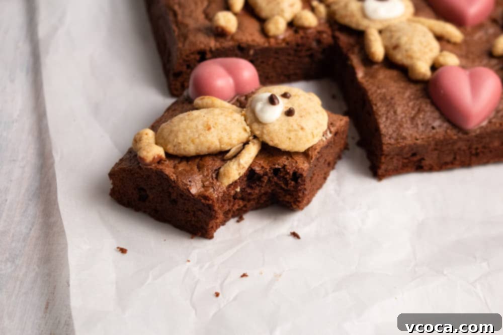 Sweetheart Teddy Bear Brownies 5 Close-up of a decorated Teddy Bear Brownie, featuring an oatmeal cookie bear with chocolate facial features and a ruby chocolate heart.