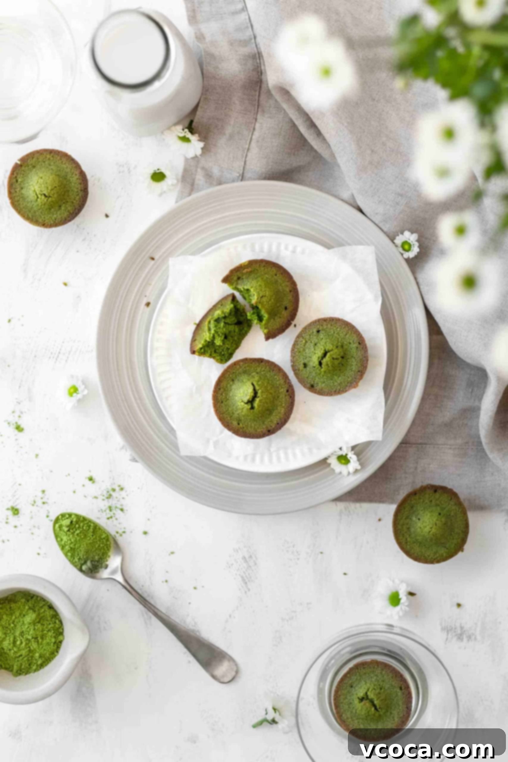 Matcha almond cake bites 5 Matcha almond cakes beautifully arranged on a white plate, ready to be enjoyed.