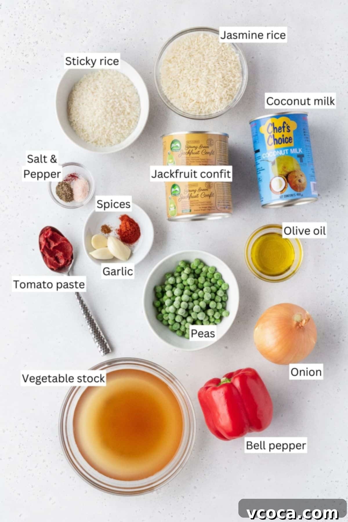 Flavorful Vegan Arroz Valenciana 4 All ingredients for making vegan Arroz Valenciana are meticulously laid out on a table with an informative text overlay, ready for cooking.