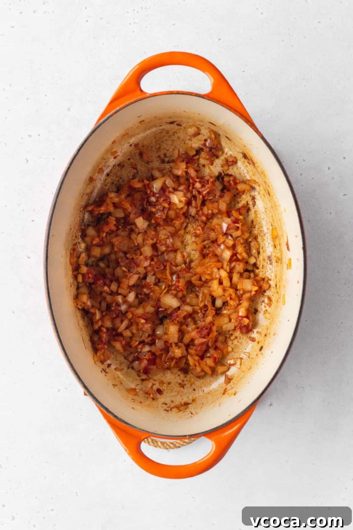 Flavorful Vegan Arroz Valenciana 7 Spices and rich tomato paste are incorporated into the sautéed onions, building the deep flavor base.