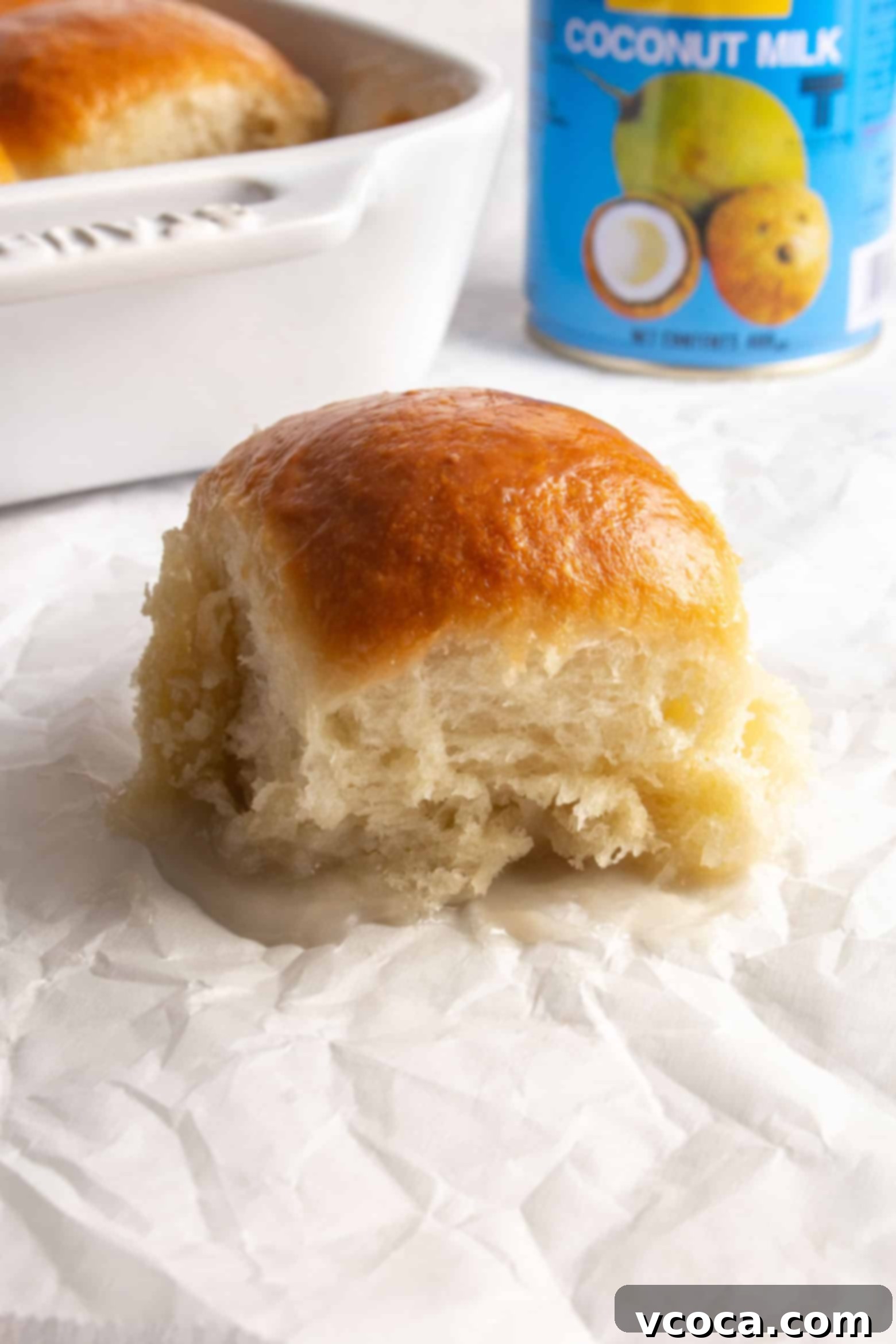 Pani Popo Samoan Sweet Coconut Buns 11 Individual Pani Popo on parchment paper, showing the sticky coconut glaze.