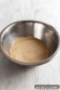 Activate dry yeast in a bowl of warm water with sugar
