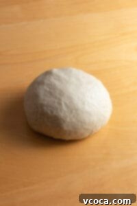 Kneaded ball of bread dough in a bowl, ready to rise