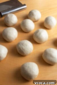 Balls of bread dough placed in a baking pan