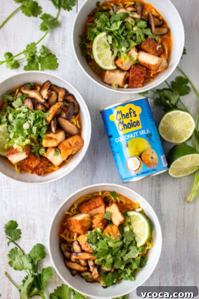 Quick and Easy Vegan Thai Red Curry Ramen 2 A steaming bowl of Vegan Thai Red Curry Ramen with deep-fried tofu, shiitake mushrooms, and fresh herbs.