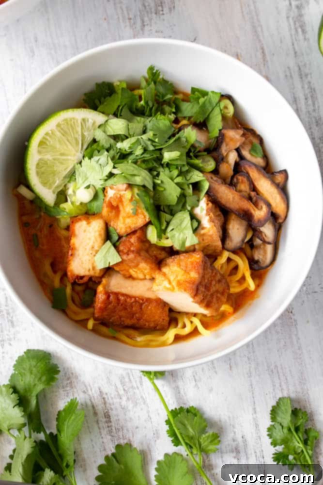 Quick and Easy Vegan Thai Red Curry Ramen 8 A close-up of the flavorful vegan Thai red curry ramen broth with noodles and toppings.