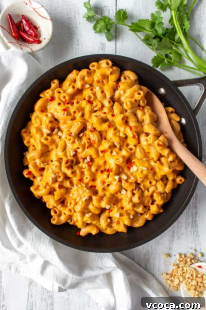 One Pot Vegan Red Curry Mac and Cheese 2 Creamy vegan red curry mac and cheese, a fusion of spicy Thai flavors and classic comfort food. Topped with fresh cilantro and a lime wedge.