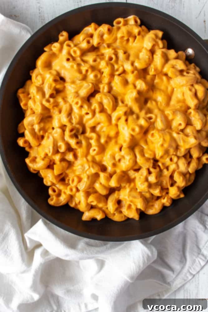 One Pot Vegan Red Curry Mac and Cheese 6 Boiling gluten-free elbow macaroni for a vegan red curry mac and cheese recipe. The pasta is perfectly al dente, ready for the spicy, zesty sauce.