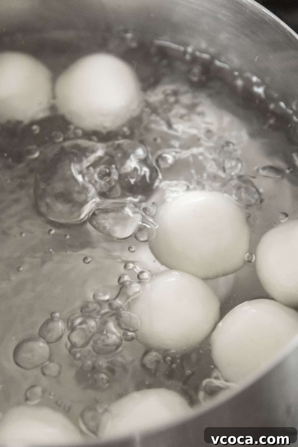 Pearl Rice Dumplings 12 Shiratama being boiled in a silver pot of water.