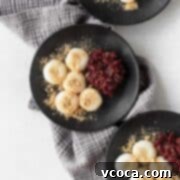 Pearl Rice Dumplings 19 Shiratama on black plates next to some sweet red bean paste and kinako sprinkled on top.