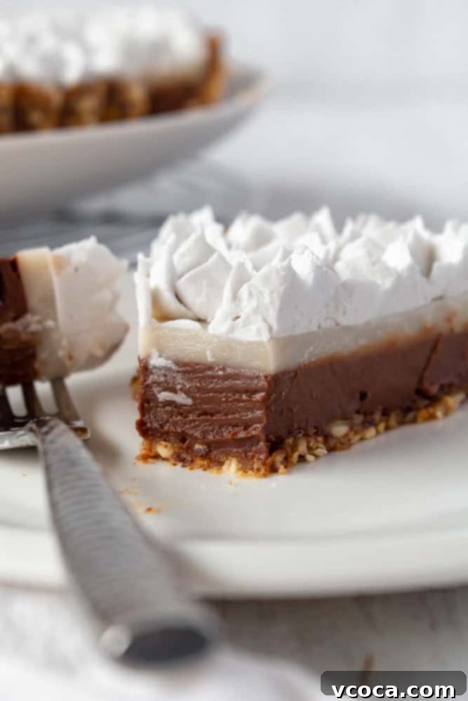 A close-up of the two distinct, creamy layers of chocolate and haupia in the vegan chocolate haupia pie, showcasing its smooth texture.