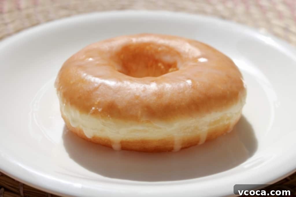 Effortless Homemade Bread Machine Doughnuts 5 Golden brown homemade doughnuts cooling on a wire rack after frying.