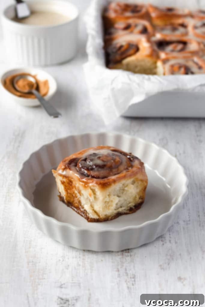 Pillowy Vegan Cinnamon Rolls with Dreamy Cashew Cream Frosting 2 Close-up of fluffy vegan cinnamon rolls topped with creamy white cashew icing