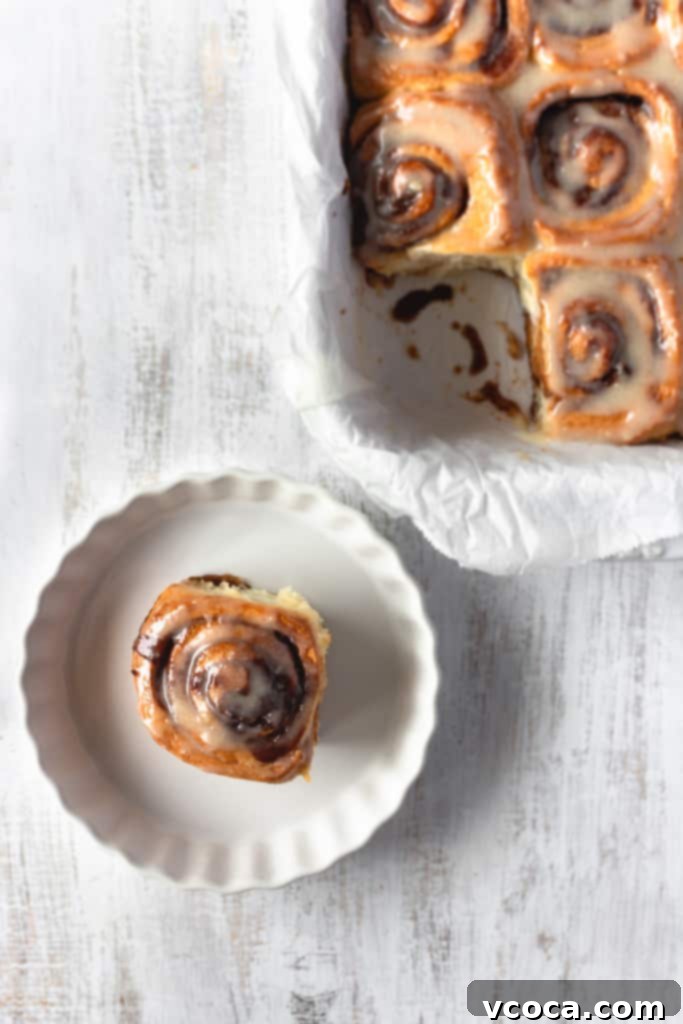 Pillowy Vegan Cinnamon Rolls with Dreamy Cashew Cream Frosting 3 A tray of freshly baked vegan cinnamon rolls with creamy icing, ready to be served