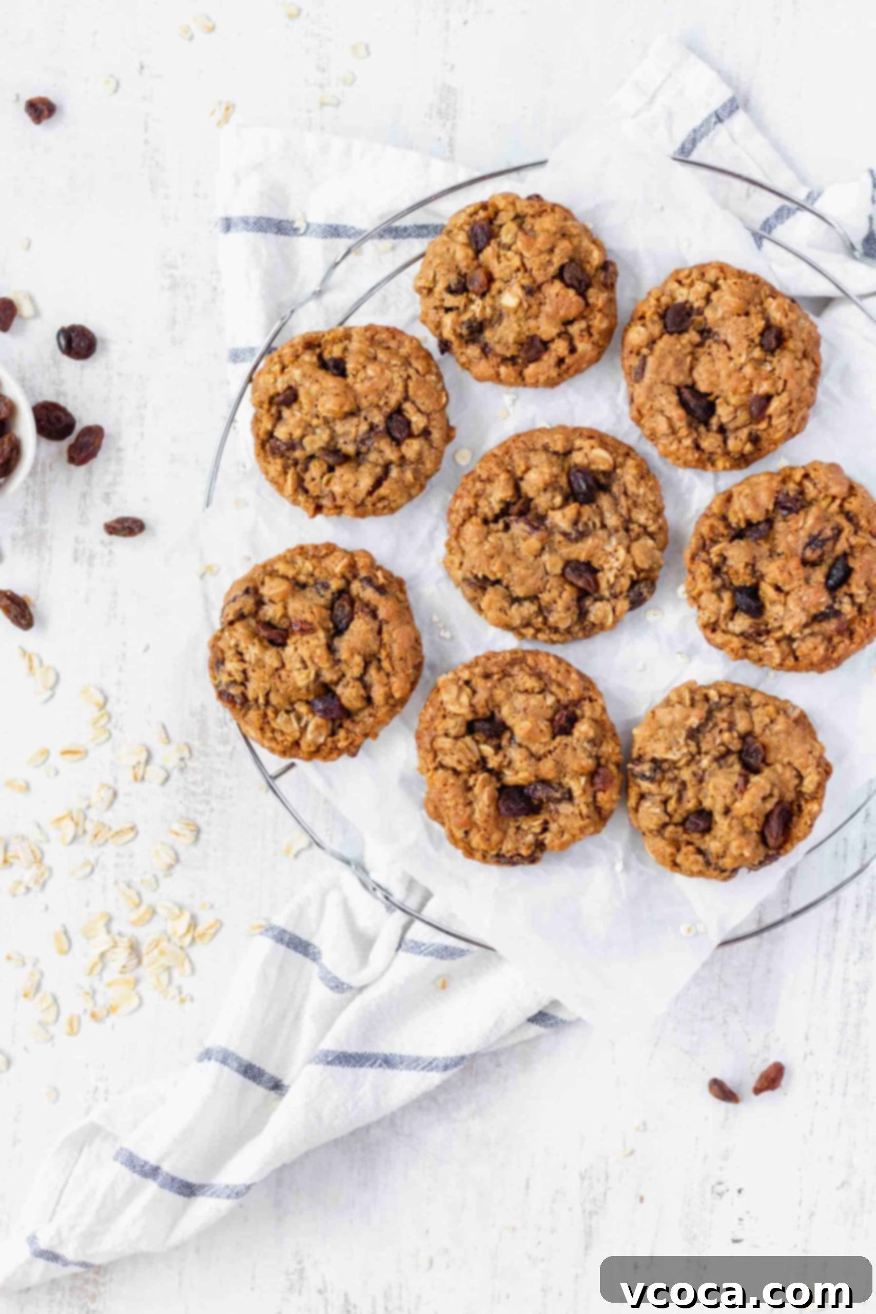 Chewy Brown Butter Oatmeal Raisin Cookies 2 Oatmeal raisin cookies freshly baked and stacked on a cooling rack