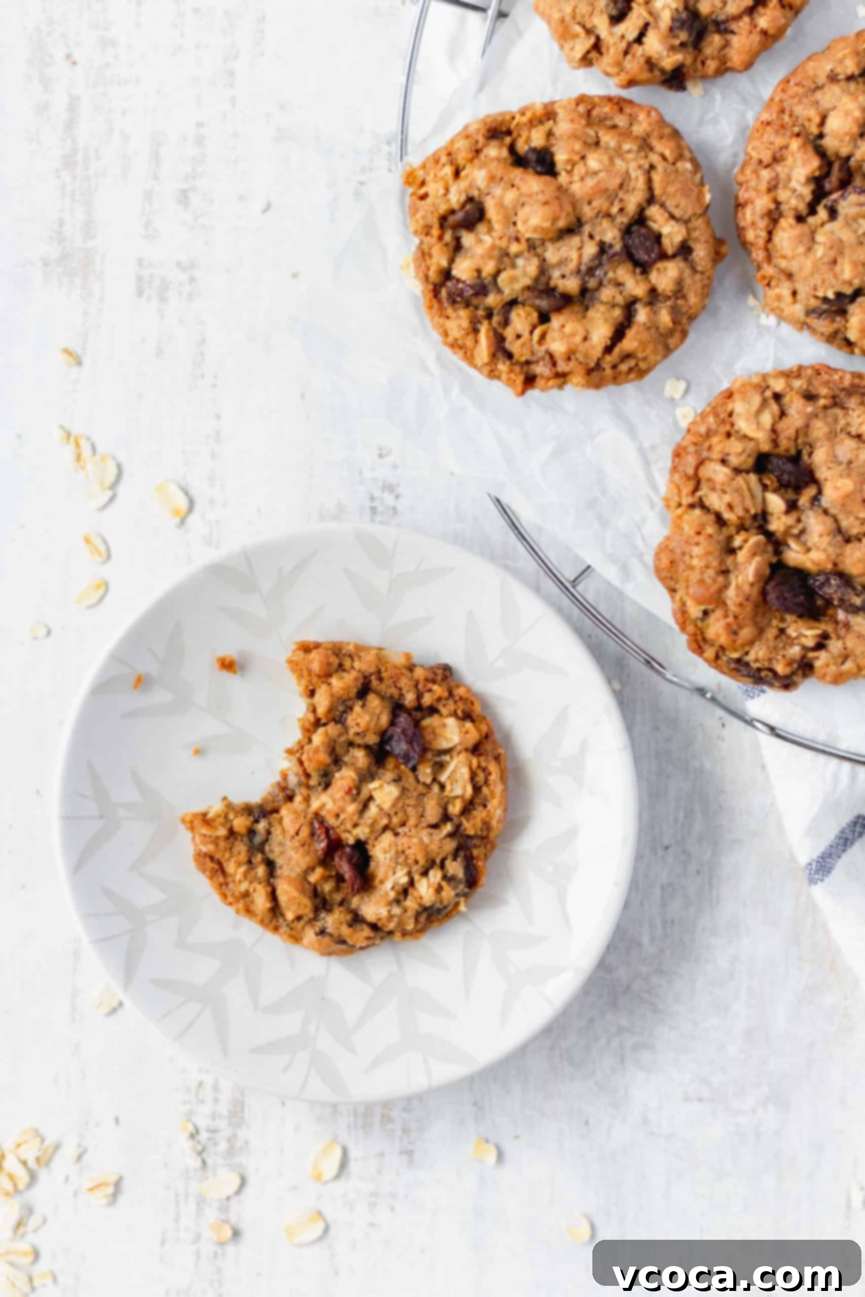Chewy Brown Butter Oatmeal Raisin Cookies 6 Close up of chewy oatmeal raisin cookies on a baking sheet, showing their soft centers