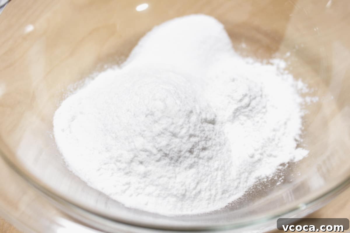 Dry ingredients for mochi added to a bowl.