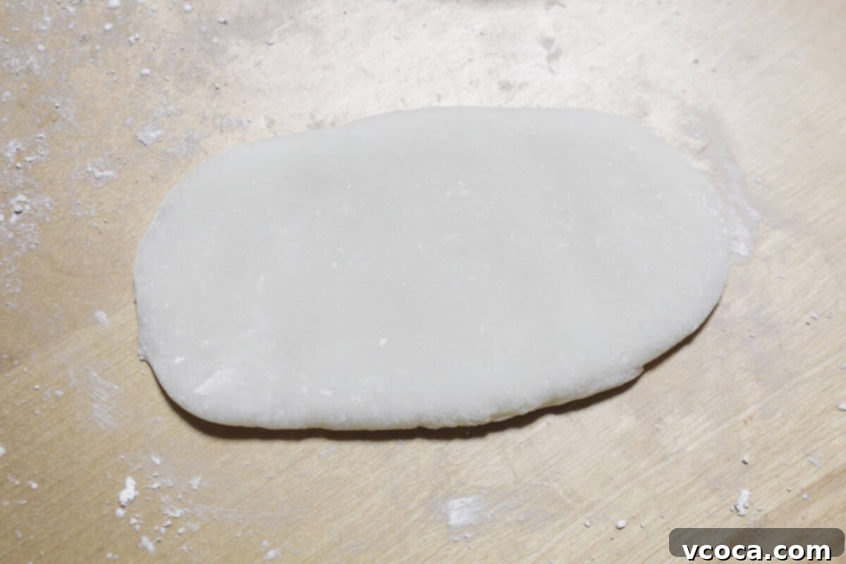 Rolling out the mochi dough into an oblong shape.