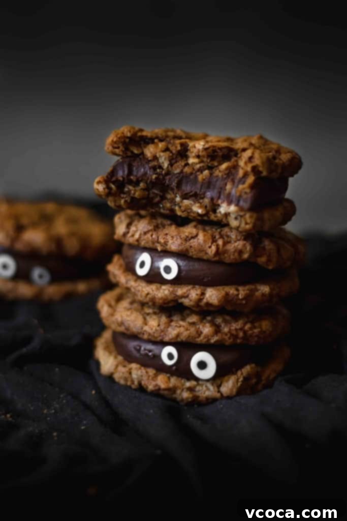 Wickedly Easy Halloween Cookies 7 Stacked monster Halloween cookies with fudge filling and candy eyes, ready to be served at a festive gathering.