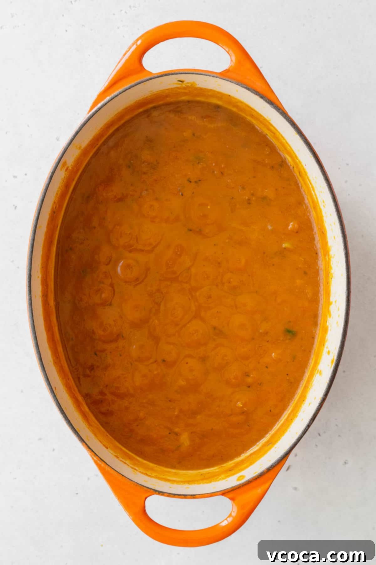 Velvety Vegan Pumpkin Soup 7 Pumpkin puree, veggie broth, and garlic powder added to the pot with the onions and spices.