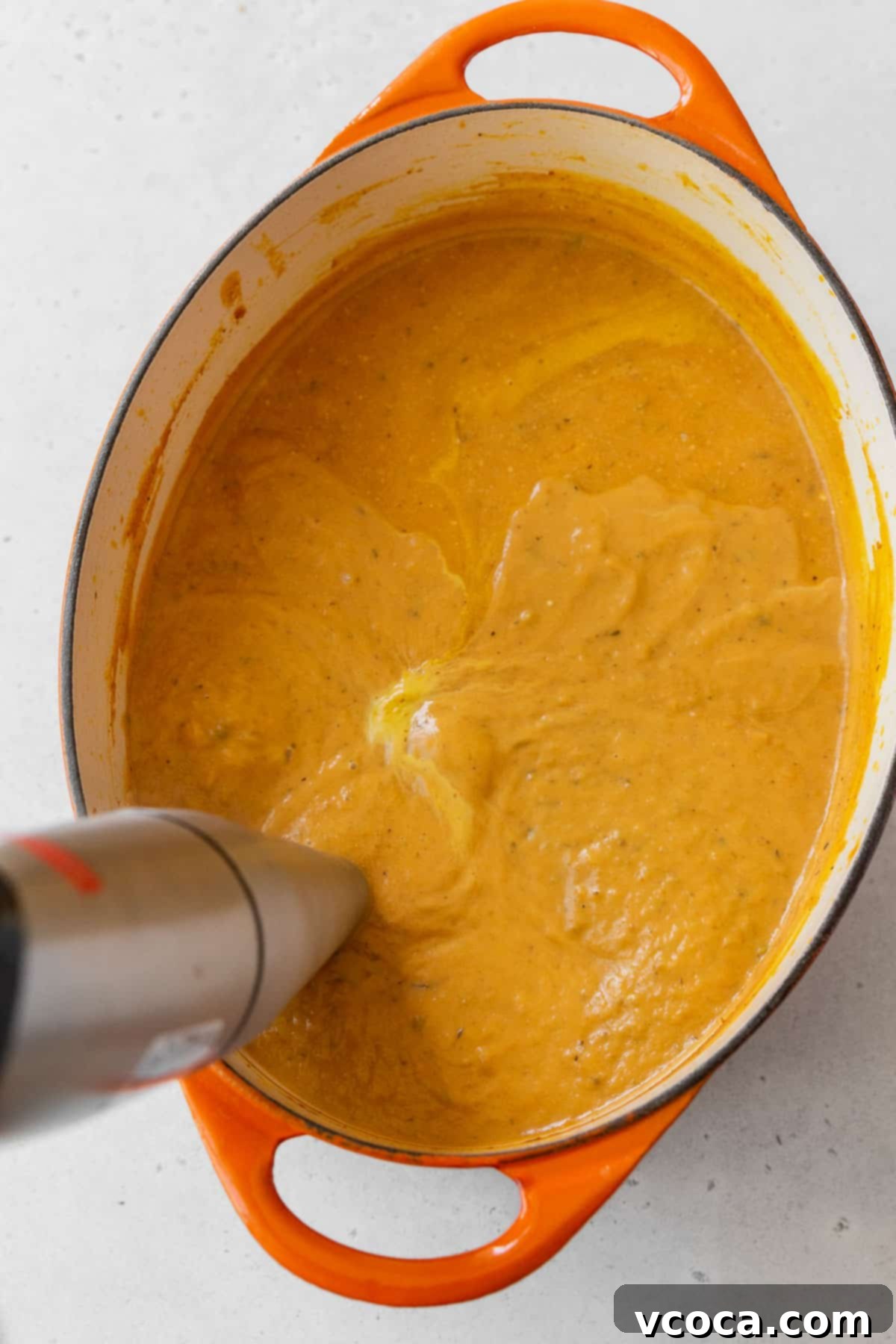 Velvety Vegan Pumpkin Soup 9 Using an immersion blender to purée the gluten-free and vegan pumpkin bisque soup.