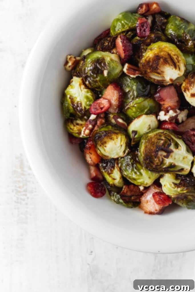 Irresistible Bacon Cranberry Pecan Roasted Brussels Sprouts 2 Perfectly roasted Brussels sprouts with crispy bacon, vibrant dried cranberries, and crunchy pecans. A delicious and easy Thanksgiving side dish.